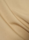 Close-up of the sand-colored cotton fabric of the Military Cotton Dockside Overshirt, showing the texture and weave of the material.