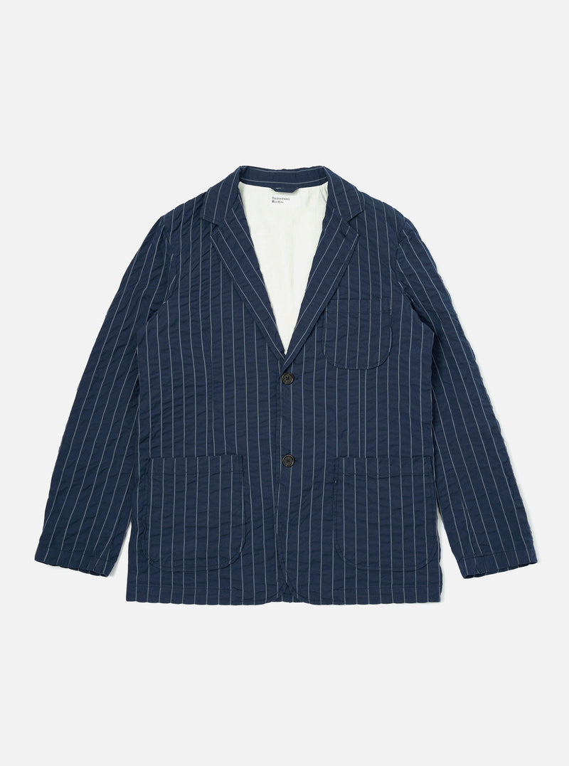 A Navy Chester Stripe Two Button Jacket is shown laid flat against a plain white background. The jacket features a thin vertical stripe pattern, two lower patch pockets, and one chest patch pocket. It has a classic notched lapel and a two-button front closure.