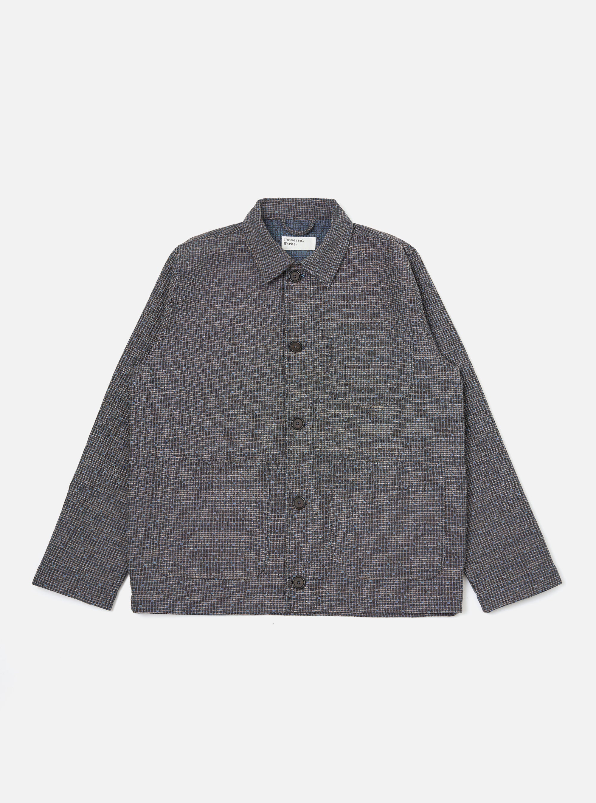 A Grey/Blue Jacquard Weave Field Jacket is shown laid flat against a solid white background. The garment features a textured jacquard-woven check pattern in shades of grey and blue, a classic pointed collar, a five-button front closure, and two large patch pockets at the waist.