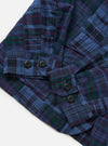 The Navy Madras Patchwork Duty Jacket is shown from a rear perspective, laid flat against a solid white background. The image highlights the vibrant blue and navy patchwork pattern, the straight hem, and the clean construction of the back panel.
