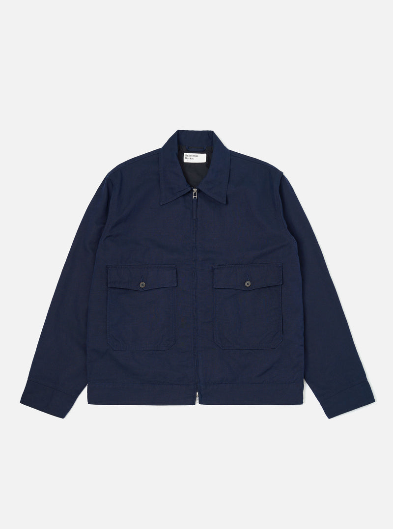 The Navy Linen Slub Weave E130 Jacket is shown laid flat against a solid white background. The jacket features a classic collar, a full-button front, and two large patch pockets at the waist. The textured slub weave of the navy linen-cotton fabric is visible throughout the garment.