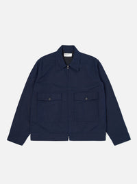 The Navy Linen Slub Weave E130 Jacket is shown laid flat against a solid white background. The jacket features a classic collar, a full-button front, and two large patch pockets at the waist. The textured slub weave of the navy linen-cotton fabric is visible throughout the garment.