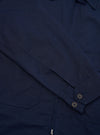 A rear view of the Navy Linen Slub Weave E130 Jacket is displayed flat against a plain white background. The image highlights the straight hem, the textured finish of the linen slub fabric, and the clean stitching across the shoulders and back panel.