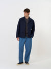 The Navy Linen Slub Weave Franck Jacket is shown laid flat against a plain white background. The jacket features a unique flat collar, a full-length front zipper, and multiple large patch pockets on the front. The fabric has a distinct textured appearance.