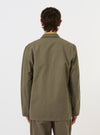 The Olive Linen Slub Weave Two Button Jacket is shown from a rear perspective, displayed flat against a plain white background. The image highlights the jacket's ventless back, structured shoulders, and the textured slub weave of the olive green fabric.