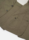 The Olive Linen Slub Weave Two Button Jacket is shown in a close-up detail view, laid flat against a plain white background. The image highlights the textured slub weave of the olive green linen-cotton fabric, focusing on the construction of a straight side flap pocket and the two-button front closure.