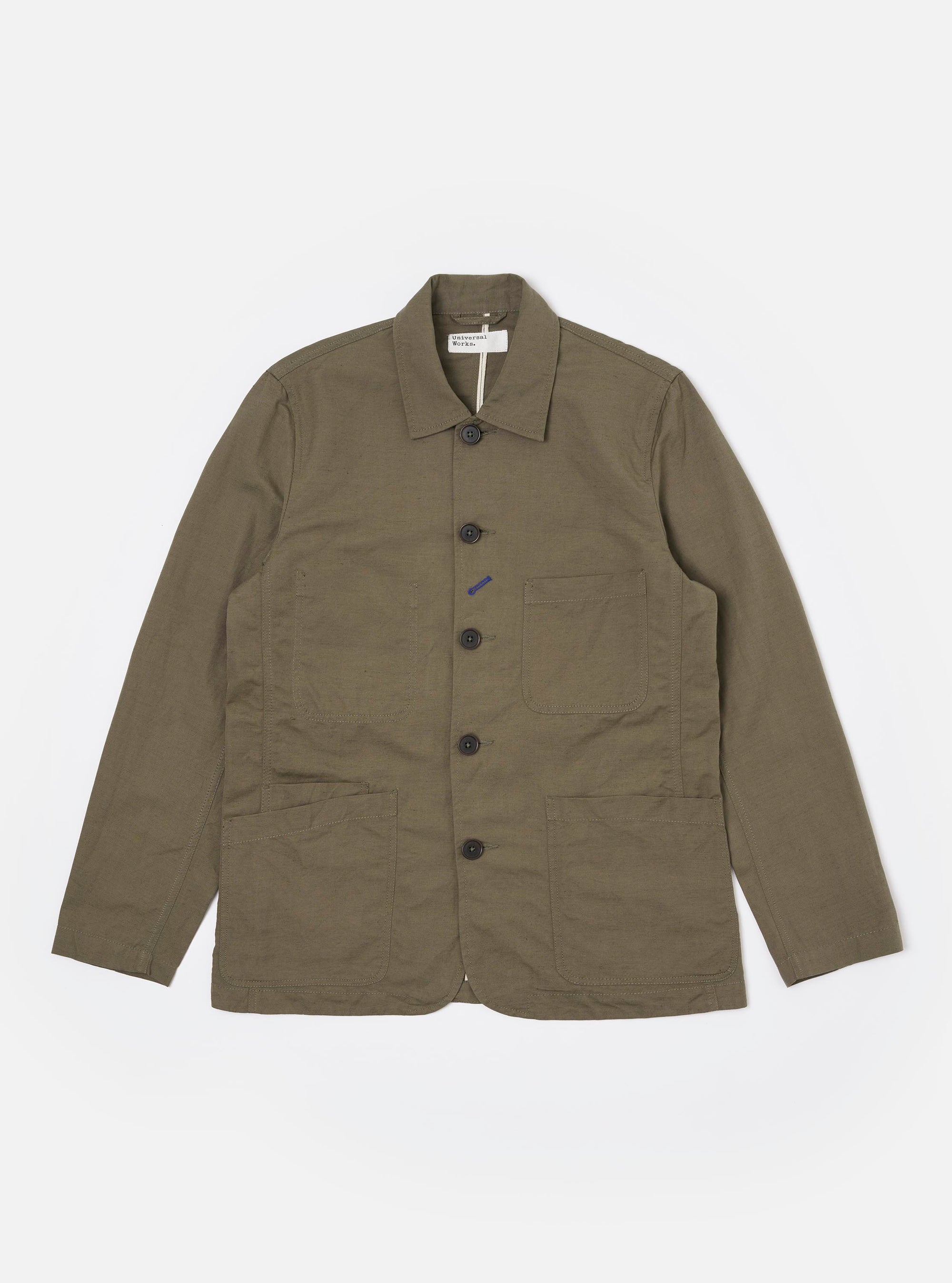 The Olive Linen Slub Weave Bakers Jacket is displayed as a flat lay against a plain white background. The jacket features a five-button front closure, a structured collar, and four front patch pockets: one at the chest and three at the waist, including a smaller ticket pocket. The olive green fabric shows a visible slubbed texture.