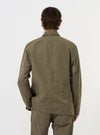 The Olive Linen Slub Weave Bakers Jacket is shown from the back, laid flat against a solid white background. The image highlights the jacket's straight hem, central seam, and the textured slub weave of the olive green linen-cotton fabric.