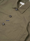 The Olive Linen Slub Weave Bakers Jacket is shown from the back as a flat lay against a plain white background. The image highlights the textured olive green linen-cotton blend fabric and the clean, straight-cut construction of the jacket's rear panel.
