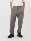 A pair of mid grey linen slub weave Dizzy trousers is displayed flat against a plain white background. The trousers feature a loose, wide leg with a slight taper, a fixed waistband, and two front angled pockets.