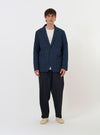 The Navy Chester Stripe Two Button Jacket is displayed flat against a plain white background. The jacket features a thin vertical stripe pattern, two front patch pockets at the hips, a single chest patch pocket, and a two-button closure with a wide lapel.