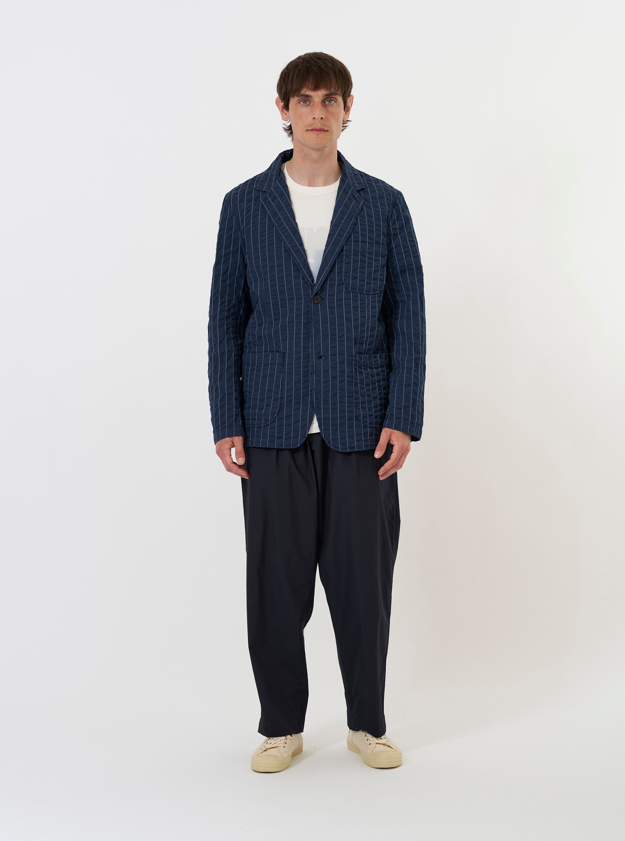 The Navy Chester Stripe Two Button Jacket is displayed flat against a plain white background. The jacket features a thin vertical stripe pattern, two front patch pockets at the hips, a single chest patch pocket, and a two-button closure with a wide lapel.