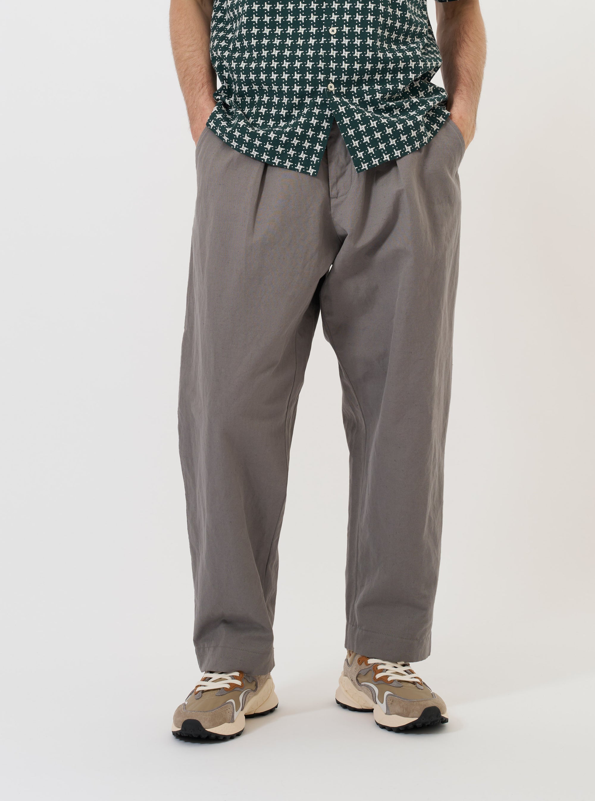 A pair of Mid Grey Linen Slub Weave Oxford Pants is displayed flat against a plain white background. The trousers feature a wide-leg silhouette, a drawstring waistband with a cream-colored cord, and side slip pockets.