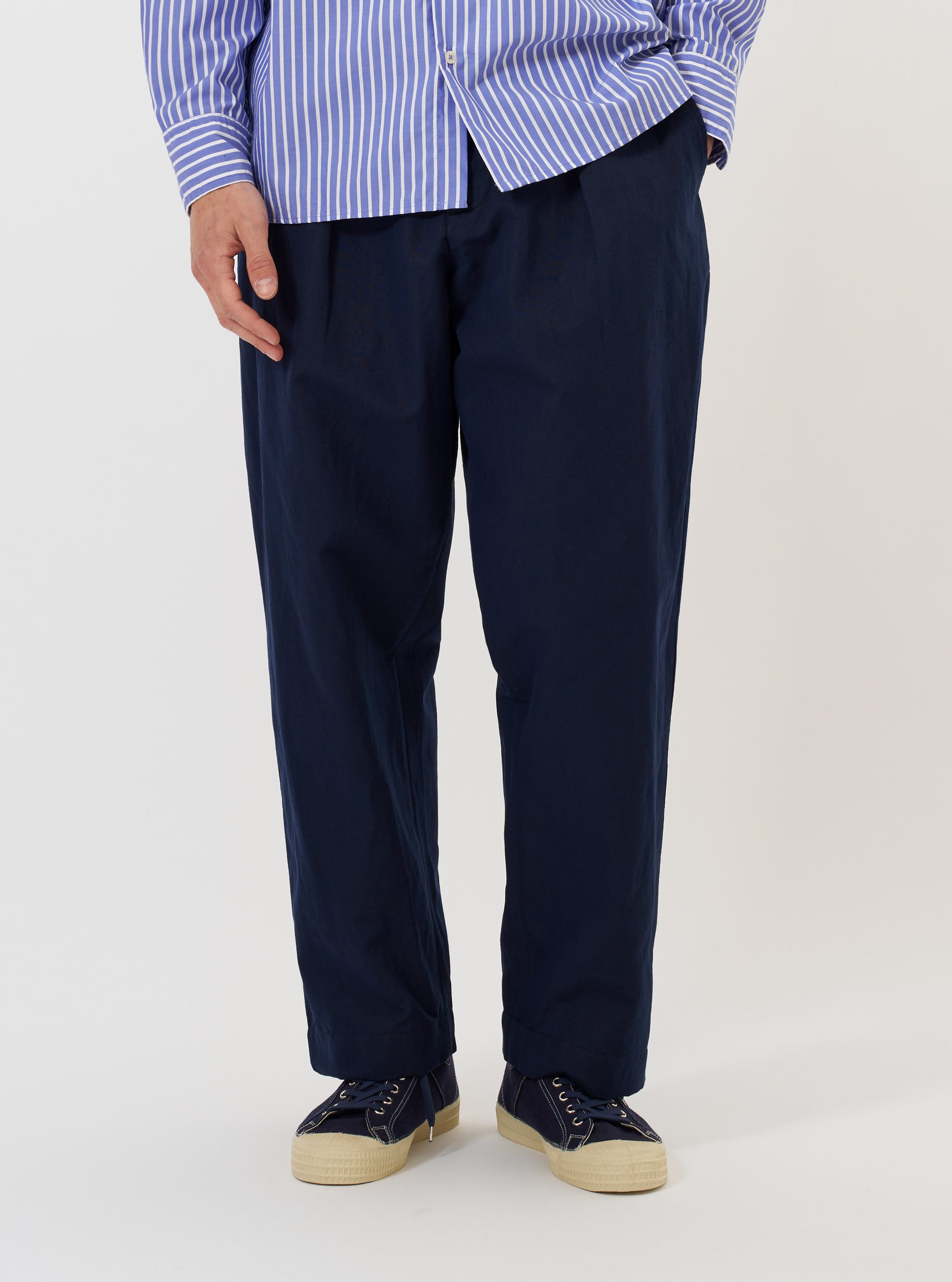 A pair of Navy Linen Slub Weave Oxford Pants is displayed flat against a solid white background. The trousers feature a wide-leg silhouette with a single pleat on each leg, an elasticated waistband with a visible drawstring, and side slip pockets.