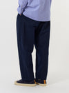 The back of the Navy Linen Slub Weave Oxford Pant is displayed flat against a plain white background. The image highlights the rear construction, featuring an elasticated waistband and two distinct back pockets: one with a buttoned flap and one button-jetted pocket.