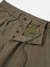 A pair of olive green linen slub weave Oxford pants is shown from a rear three-quarter angle, laid flat against a plain white background. The image highlights the relaxed, wide-leg fit and the textured appearance of the slub fabric. A single rear patch pocket with a button closure is visible on the right side.