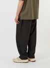A model is wearing the Brown Marl Tropical Suiting Dutch Pant against a plain white background. The image is taken from a side-rear perspective, highlighting the wide-leg fit of the brown trousers, the stitched-down front darts, and a rear patch pocket. No mannequin is present in the image.