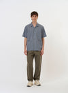 The Pale Blue Check Plaid Summer Overshirt is shown laid flat against a solid white background. The garment features a light blue and white plaid pattern, a classic pointed collar, a full button-down front, and two large chest pockets with buttoned flaps.