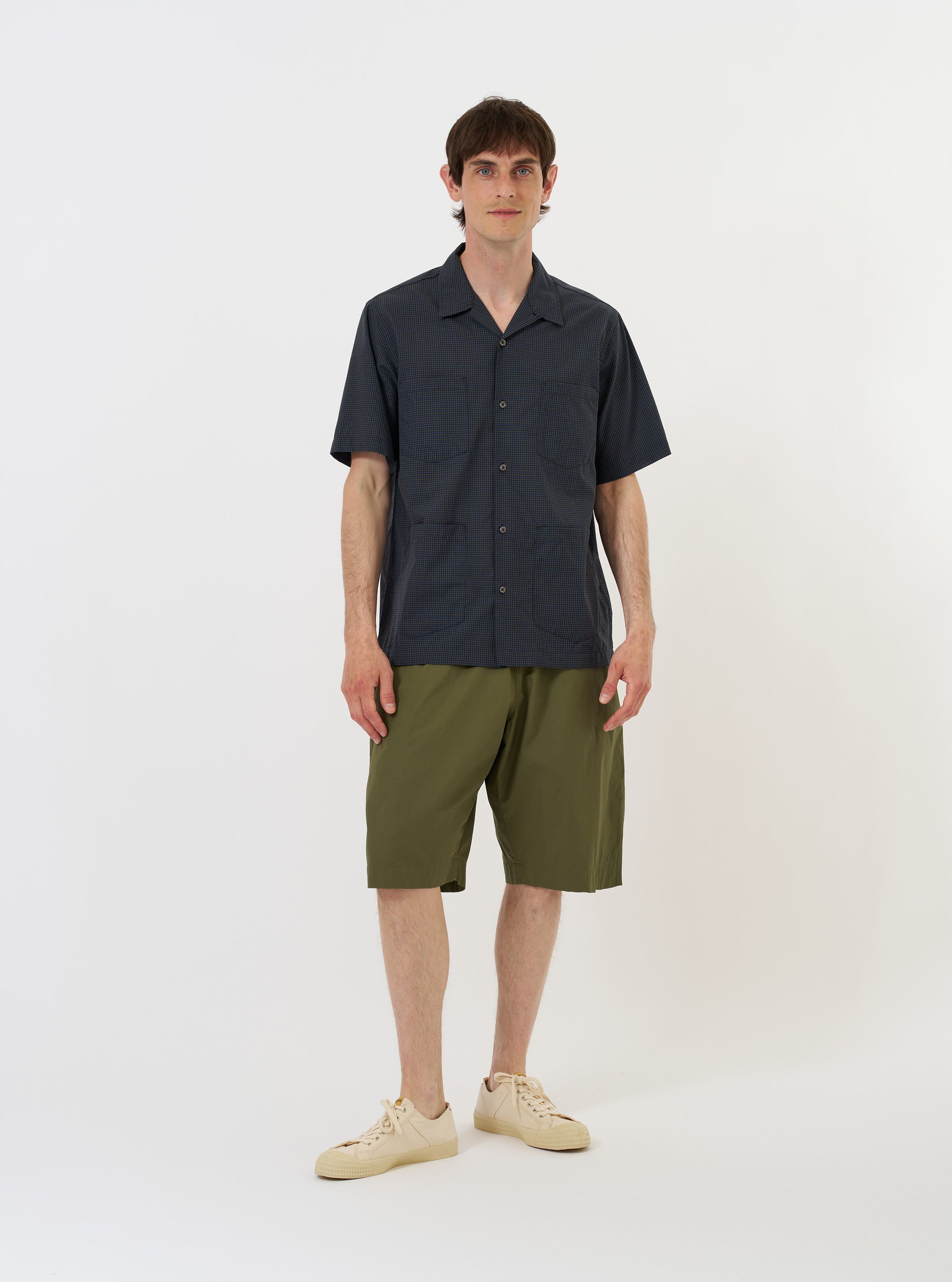 The Navy Check Plaid Summer Overshirt is displayed flat against a plain white background. The garment features a dark navy and white plaid pattern, a pointed collar, and a full button-down front.
