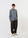 The Pale Blue Check Plaid Lazy Day Shirt is shown laid flat against a plain white background. The shirt is a long-sleeve button-down with a pointed collar, a single asymmetric chest pocket on the left side, and a straight hem. The fabric features a small-scale pale blue and white check pattern.