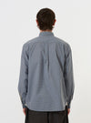A model is wearing the Pale Blue Check Plaid Lazy Day Shirt, standing against a plain white background. The image shows the shirt from the back, highlighting the yoke, the hang loop, and the subtle texture of the pale blue plaid pattern. The model has their hands in their pockets, and the shirt is paired with dark trousers.