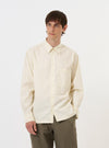 The Ecru Broadcloth Lucky Shirt is displayed flat against a plain white background. The garment is a short-sleeved button-down shirt featuring a relaxed fit, a classic pointed collar, and a straight hem. The fabric is a solid ecru or off-white color with a smooth broadcloth texture.