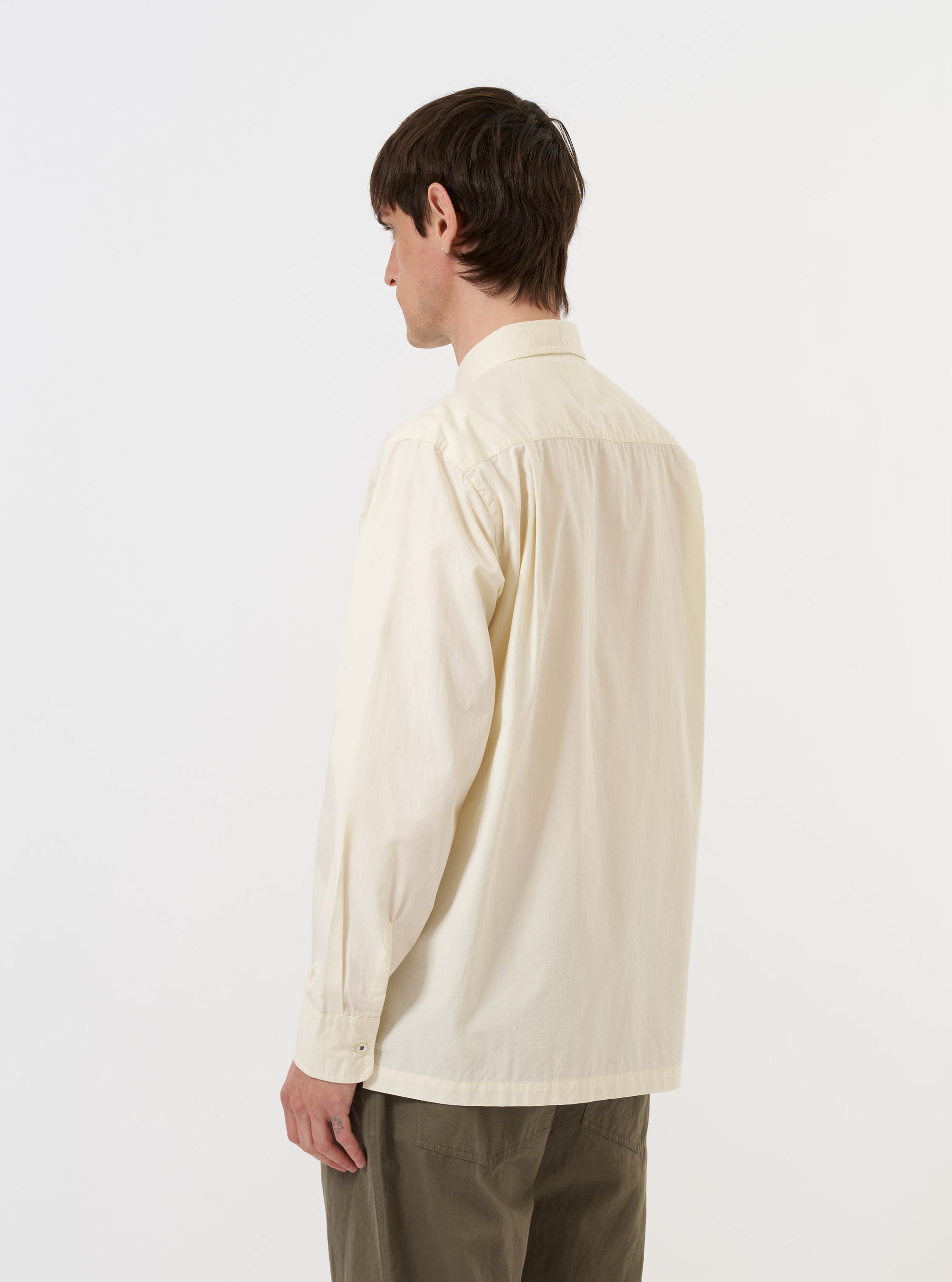 The back of the Ecru Broadcloth Lucky Shirt is shown laid flat against a plain white background. The image highlights the horizontal back yoke and the smooth texture of the ecru cotton broadcloth.