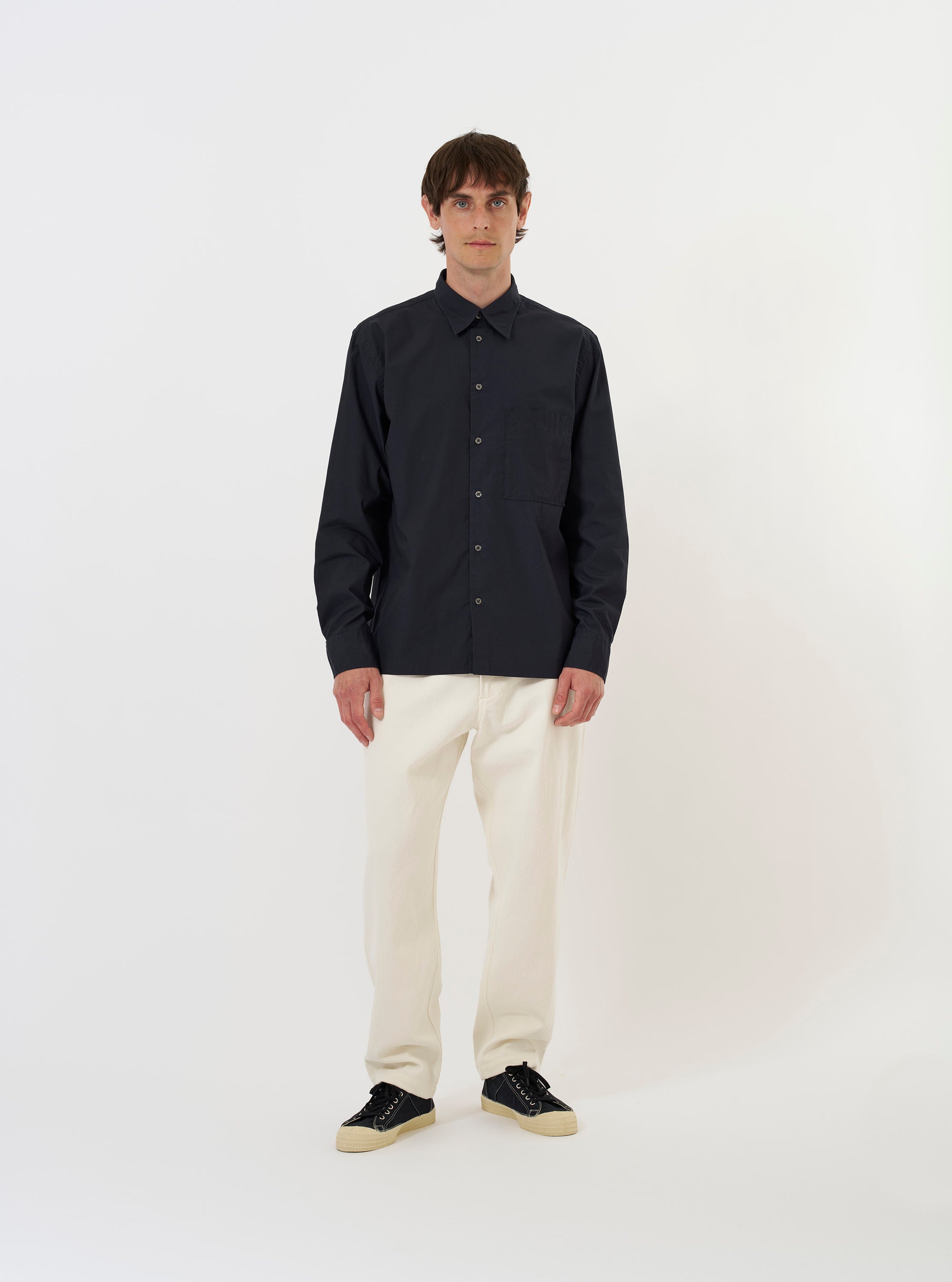 The Navy Broadcloth Lucky Shirt is displayed flat against a plain white background. The shirt features a relaxed fit with short sleeves, a classic camp collar, a full button-down front, and a single chest patch pocket.