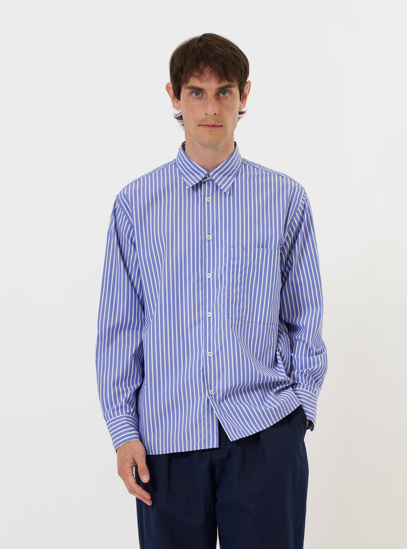 The Blue/White Cotton Stripe Square Pocket Shirt is displayed flat against a plain white background. The shirt features a vertical blue and white stripe pattern, a classic pointed collar, a full button-down front, and a prominent square patch pocket on the left chest.
