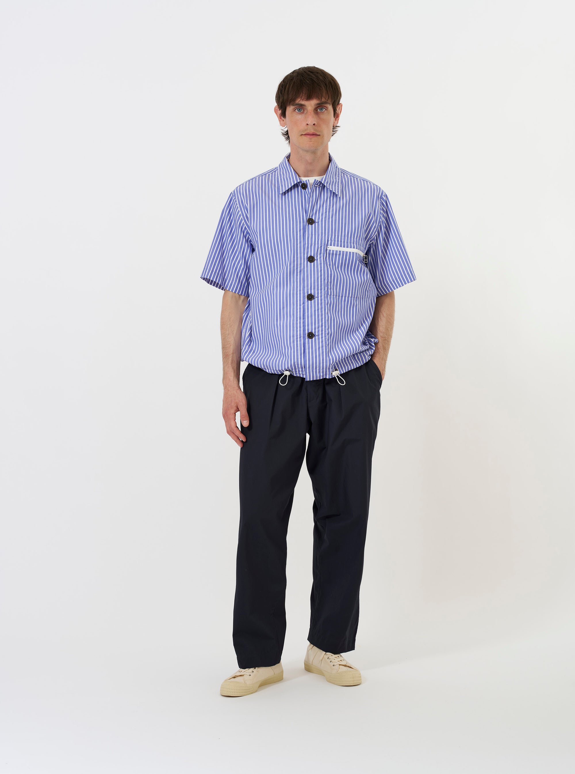 The Blue/White Cotton Stripe Z Tech Overshirt is shown laid flat against a plain white background. The garment features vertical blue and white stripes, a classic pointed collar, a full button-down front, and two large utility chest pockets.