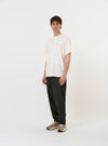 The Ecru Single Jersey Wish Wish You Were Here Tee is shown laid flat against a plain white background. The short-sleeve t-shirt is an ecru color and features a graphic on the front with the handwritten text Wish You Were Here above a small illustration. The garment has a classic crew neckline and a straight hem.