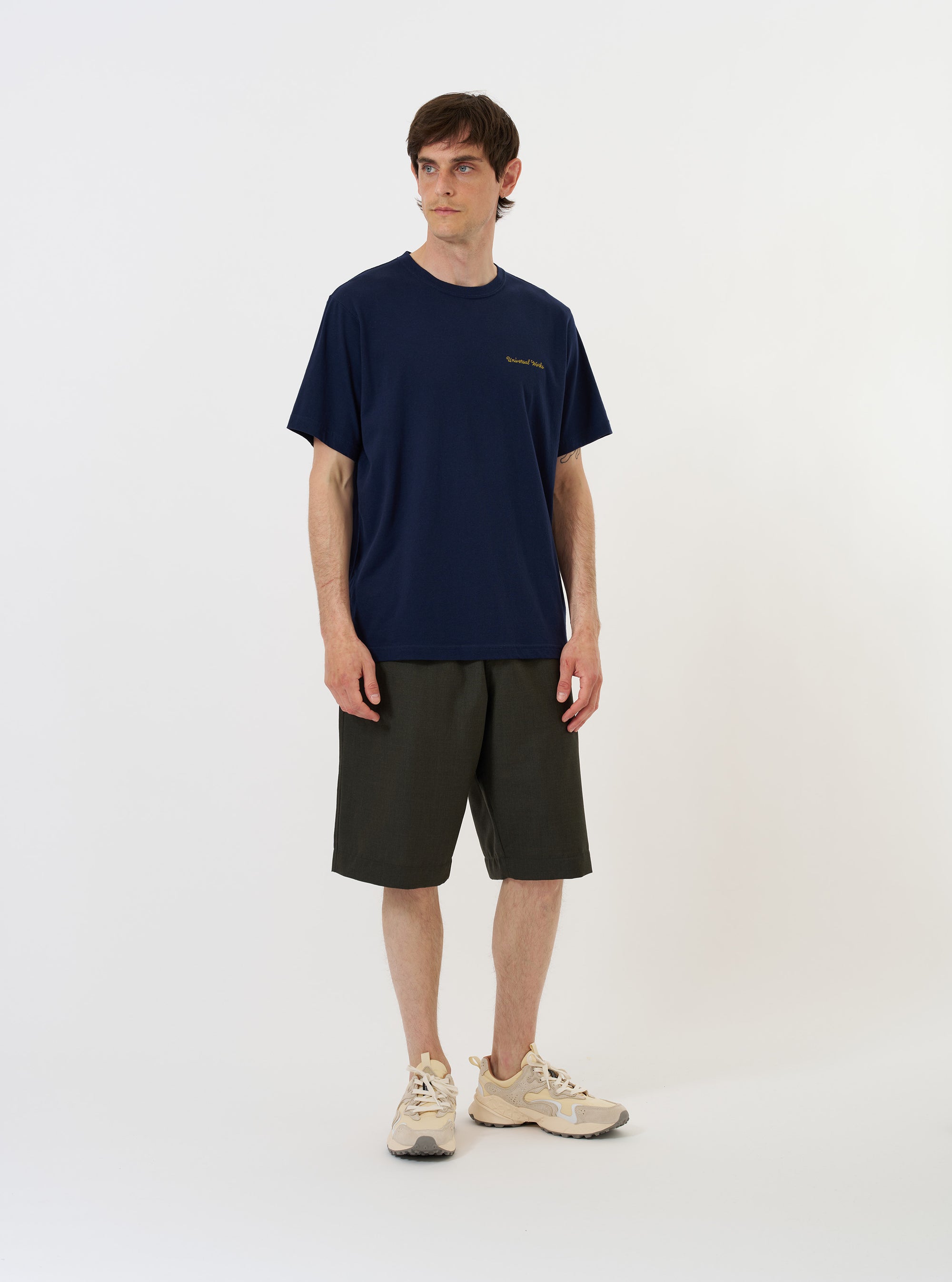 The Navy Single Jersey Wish Wish You Were Here Tee is shown laid flat against a solid white background. The navy blue t-shirt features a crew neckline, short sleeves, and a prominent white graphic on the chest with the text Wish You Were Here and an illustrated sun and sea scene.