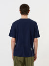 A model is shown from the back wearing the Navy Single Jersey Trail Trail To Hotel Delux Tee against a plain white background. The navy blue t-shirt features a relaxed fit, short sleeves, and a clean, straight hem. No other garments or accessories are visible.