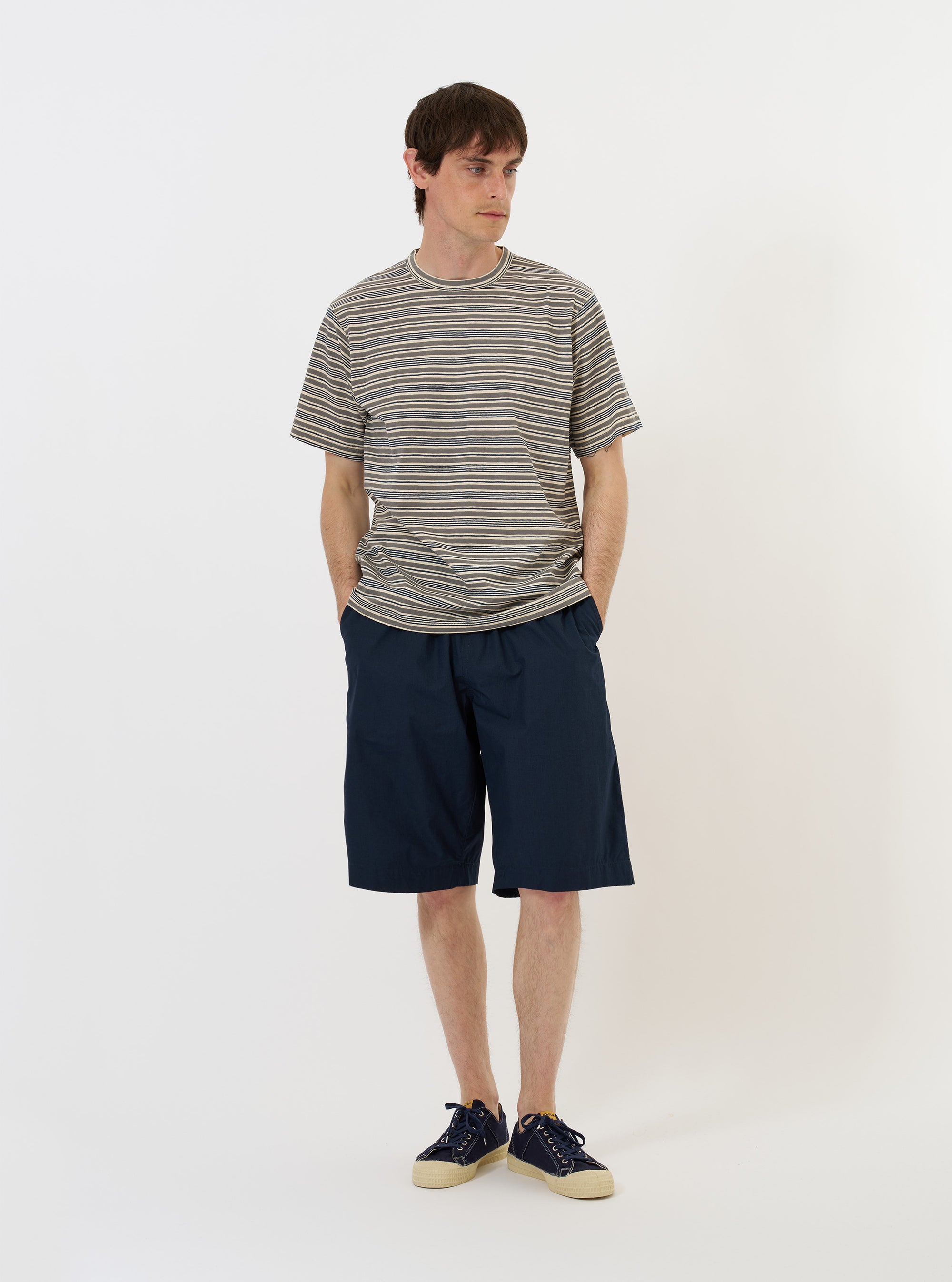 A Grey OS Stripe Jersey Core Tee is shown laid flat against a solid white background. The short-sleeve T-shirt features a horizontal grey and white striped pattern, a classic crew neckline with a self-bound collar, and a boxy, generous fit.