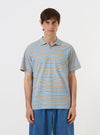 The Pale Blue OS Stripe Jersey Vacation Polo is shown laid flat against a plain white background. The shirt features a light blue and white horizontal stripe pattern, a relaxed open neck with a single-piece collar, a short front placket, and a single patch pocket on the left chest.