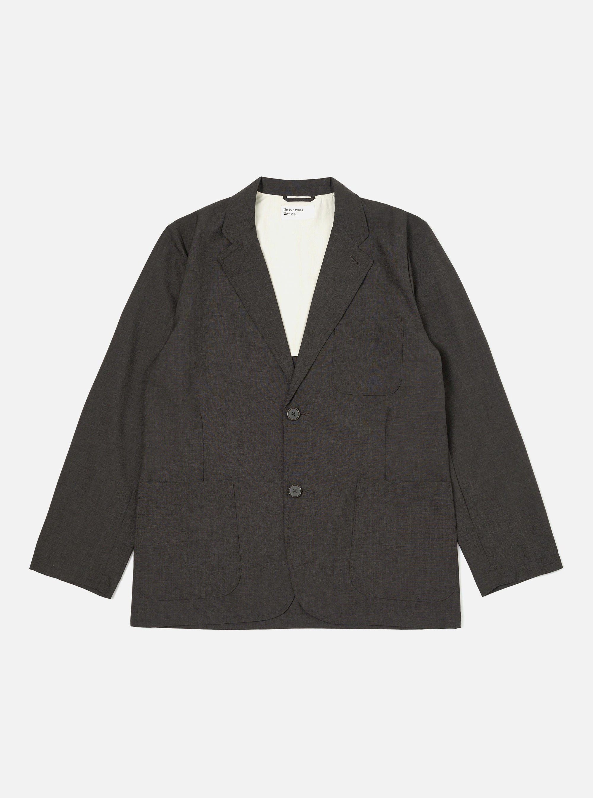 The Brown Marl Tropical Suiting Two Button Jacket is displayed flat against a plain white background. The garment features a two-button front closure, long and wide lapels, two lower patch pockets, and a single chest patch pocket.
