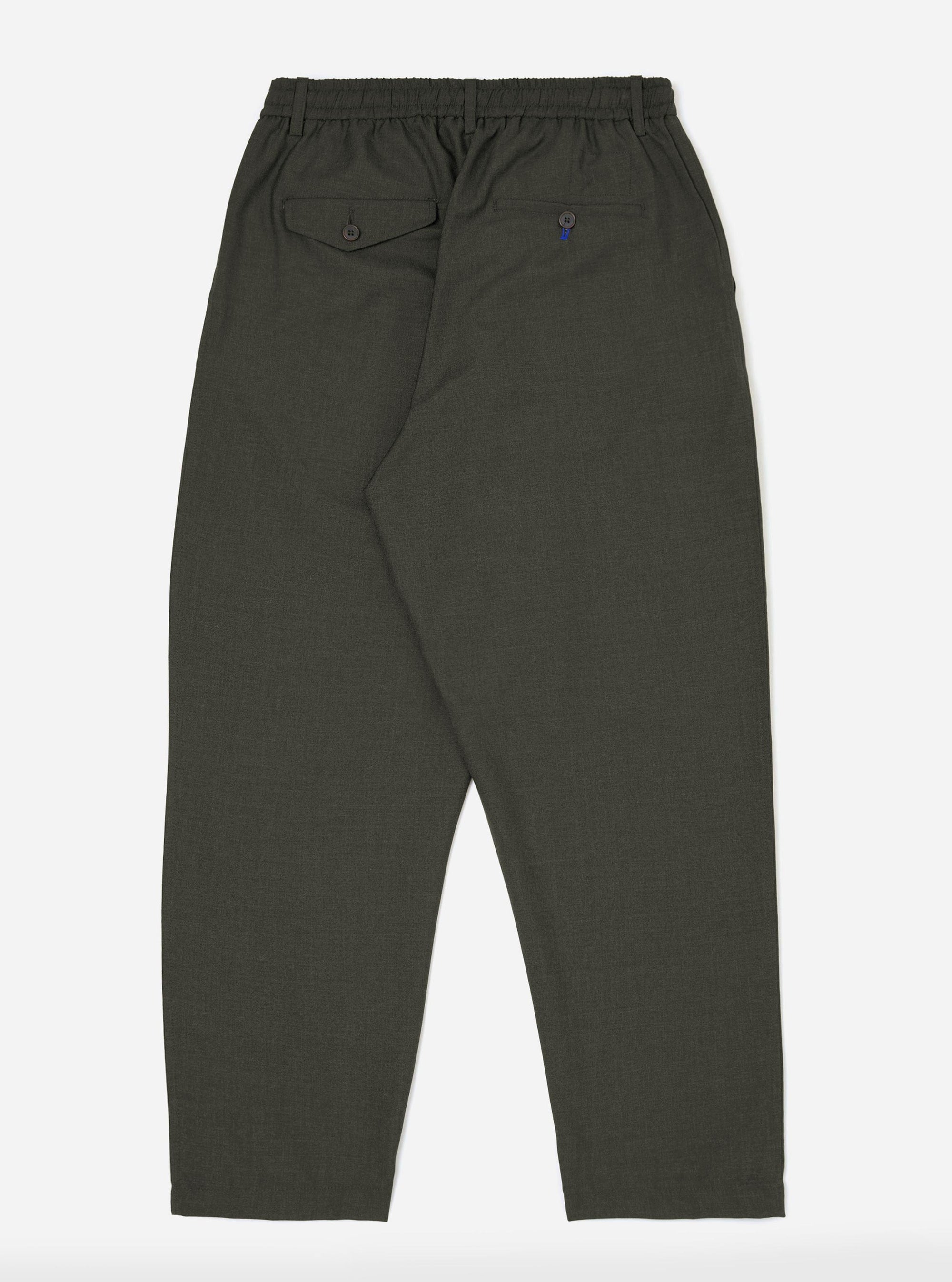 The back of the Olive Marl Tropical Suiting Pleated Track Pant is displayed flat against a plain white background. The olive green trousers feature a tapered leg, an elasticated drawstring waistband, and a single rear buttoned pocket.