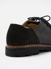 Close-up of the Paraboot x Universal Works Michael in Black Leather/Suede. The shoe features black leather and suede, with a welted sole. Shot on a white background.