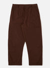 The Paraboot x Universal Works Brown Peached Poplin Super Chino is shown as a flat lay against a white background. The trousers feature a wide, relaxed fit with a single pleat front, a button fly, and a distinct turn-up cuffed hem. The fabric is a smooth, solid brown peached poplin.