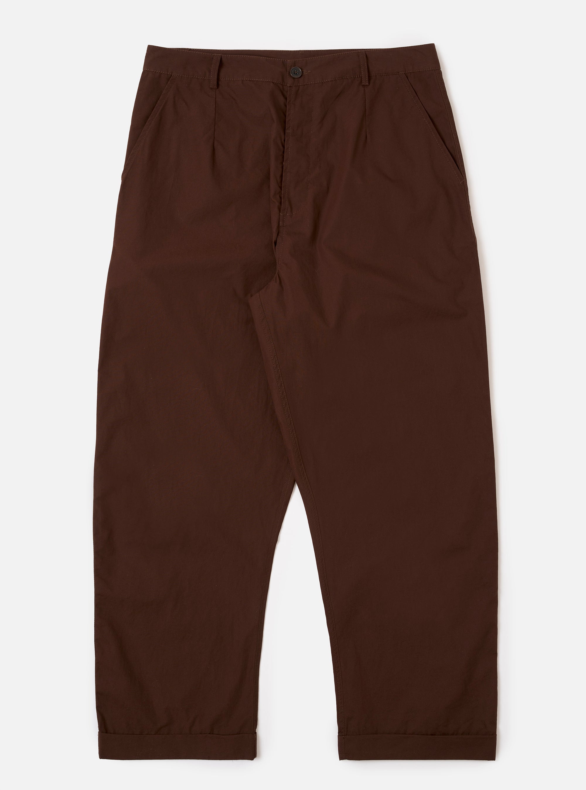 The Paraboot x Universal Works Brown Peached Poplin Super Chino is shown as a flat lay against a white background. The trousers feature a wide, relaxed fit with a single pleat front, a button fly, and a distinct turn-up cuffed hem. The fabric is a smooth, solid brown peached poplin.