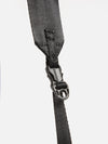 Close-up of the black nylon strap and buckle of the F/CE.® Green Nylon 2.5 Layer Sacoche against a white backdrop. The strap's texture and buckle details are clearly visible.