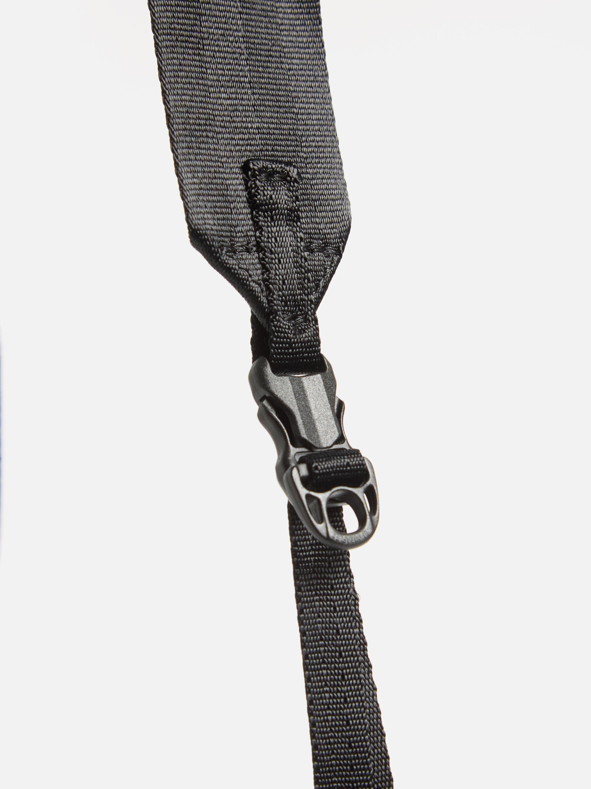 Close-up of the black nylon strap and buckle of the F/CE.® Green Nylon 2.5 Layer Sacoche against a white backdrop. The strap's texture and buckle details are clearly visible.