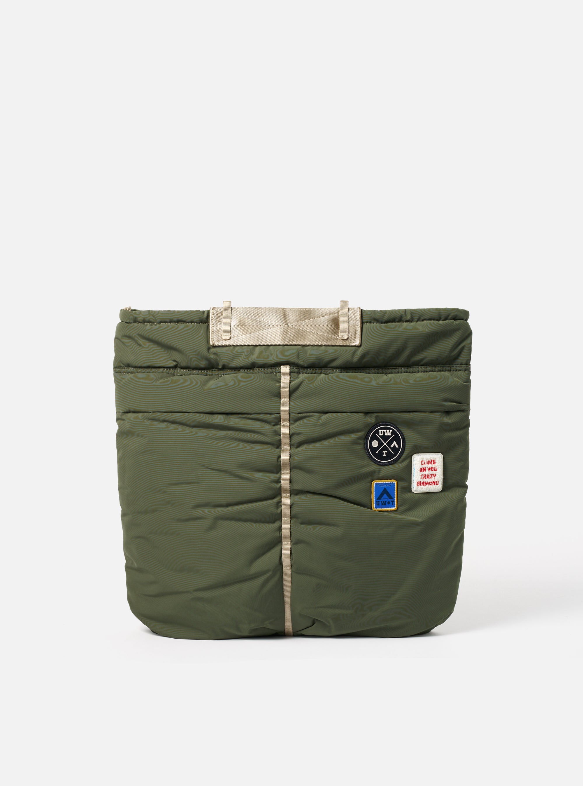 Topologie x Universal Works Rifle Green UW Tech Helmet Bag on a white background. The bag is quilted with beige straps and patches.