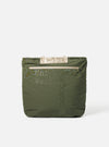 Topologie x Universal Works Rifle Green UW Tech Helmet Bag on a white background. The bag is green with beige accents and has the brand names embossed on the front.