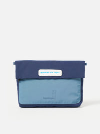 Topologie x Universal Works Insignia Blue UW Tech Musette Medium on a white background. The bag is two-tone blue with a patch that reads "IN ROCKS WE TRUST".