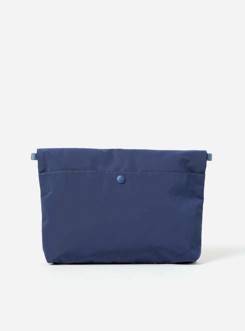 The Topologie x Universal Works Insignia Blue UW Tech Musette Medium bag on a white background. The bag is a deep blue color and made of a smooth, technical material.