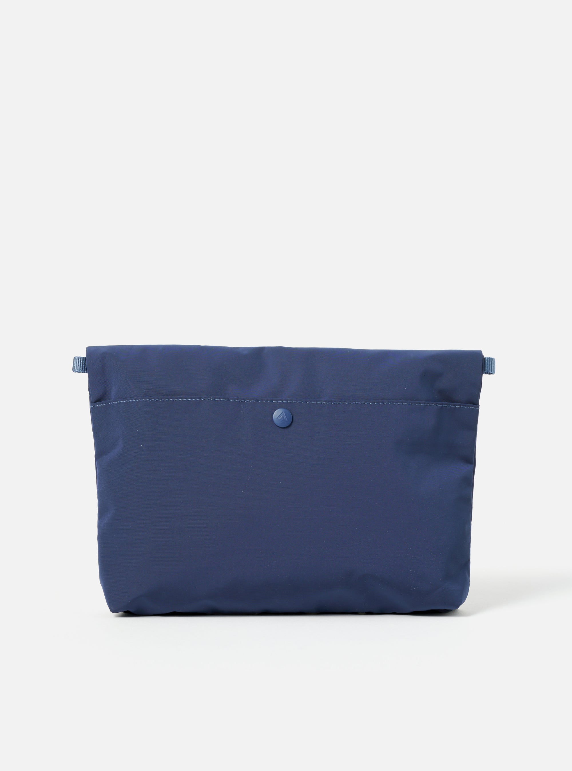 The Topologie x Universal Works Insignia Blue UW Tech Musette Medium bag on a white background. The bag is a deep blue color and made of a smooth, technical material.