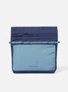 The Topologie x Universal Works Insignia Blue UW Tech Musette Medium bag on a white background. The bag is blue with a lighter blue pocket featuring the brand logos.