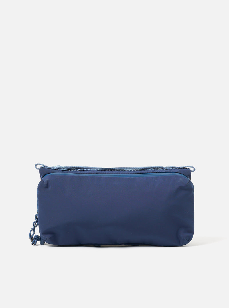 The Topologie x Universal Works Insignia Blue UW Tech Bottle Sacoche Medium. A dark blue bag with blue rope detailing, on a white background. 