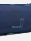 Close-up of the Topologie x Universal Works Insignia Blue UW Tech Bottle Sacoche Medium. The blue fabric bag features the logos of both brands in a lighter blue.